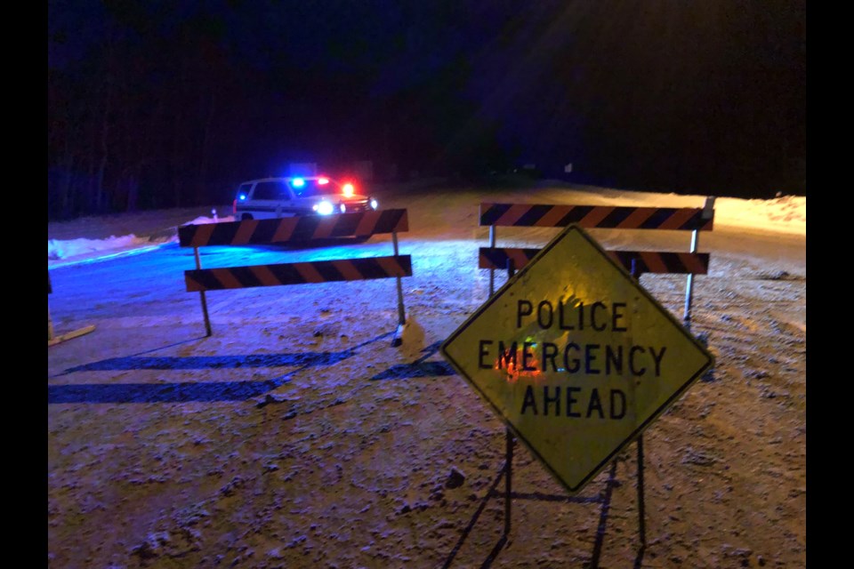 A Lac La Biche County Peace Officer vehicle sits behind barricades at the  intersection of Highway 36 and the Truck Route on Monday night.