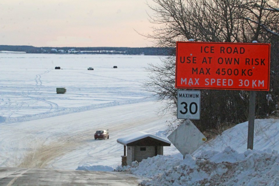 A vehicle drives onto the recently-opened Lac La Biche lake ice road from the Poplar Point access on Friday afternoon.