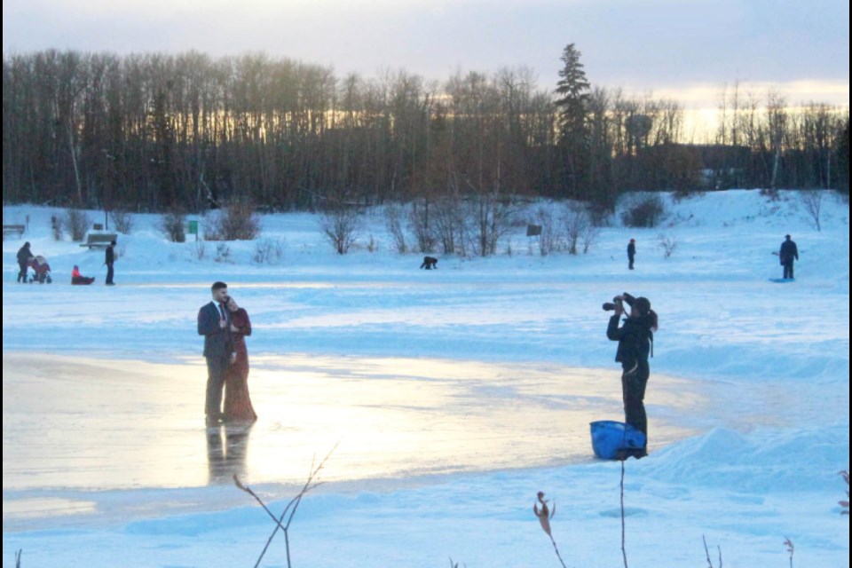 Dixie's Photography owner Dalyla Abougouche snaps one of many photos of soon-to-be-weds Loody Fayad and Sydney Hutton on a chilly afternoon on the frozen surface of theAlexander Hamilton trout pond