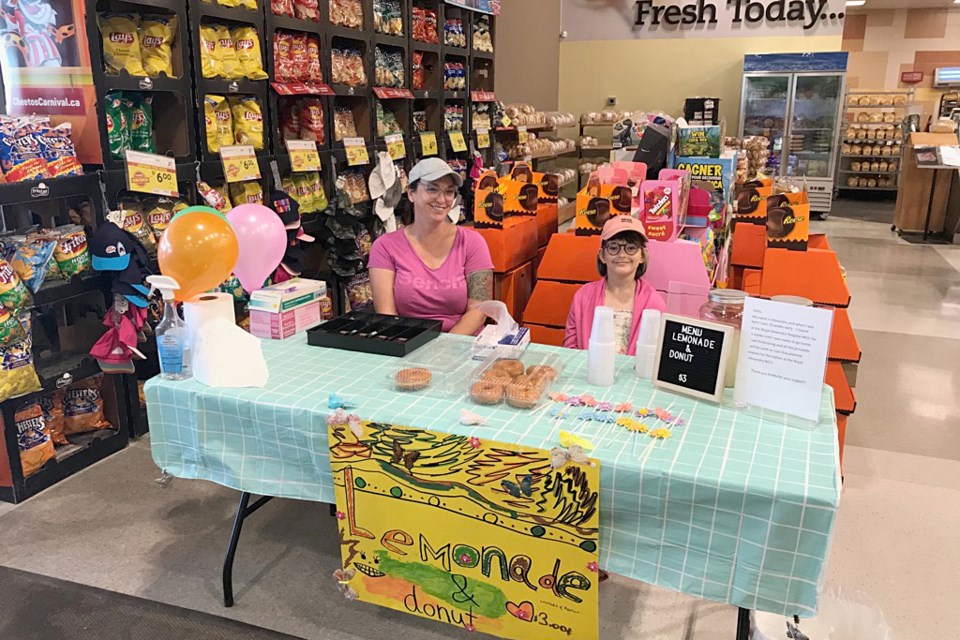 Carmen and Alexandra Kerr are pictured during a lemonade fundraiser, held on July 16 at Sobeys.