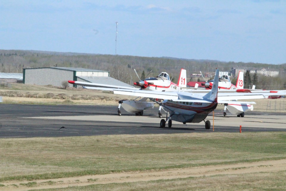 Air Tractor water bombers and the 'bird dog' lead plane at the Lac La Biche Air Tanker Base.