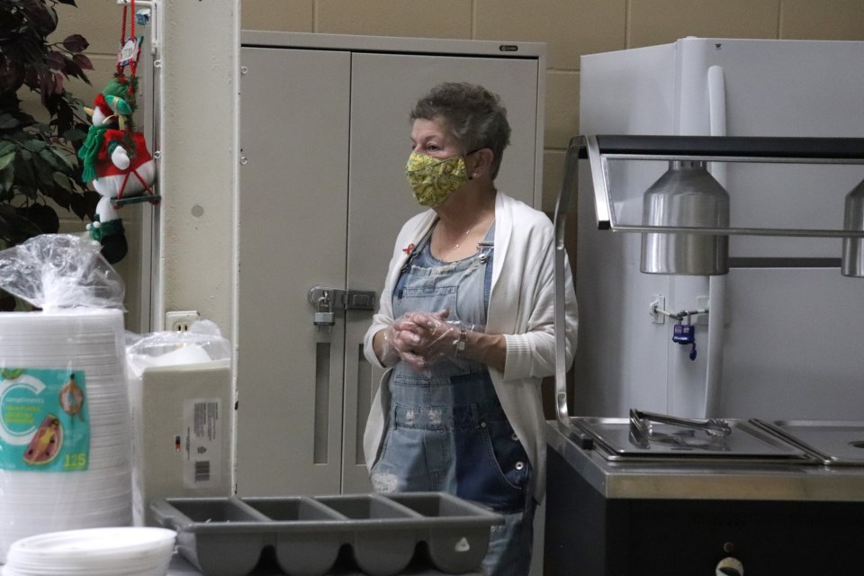 Judith Hess with Community Futures helps serve pancakes.