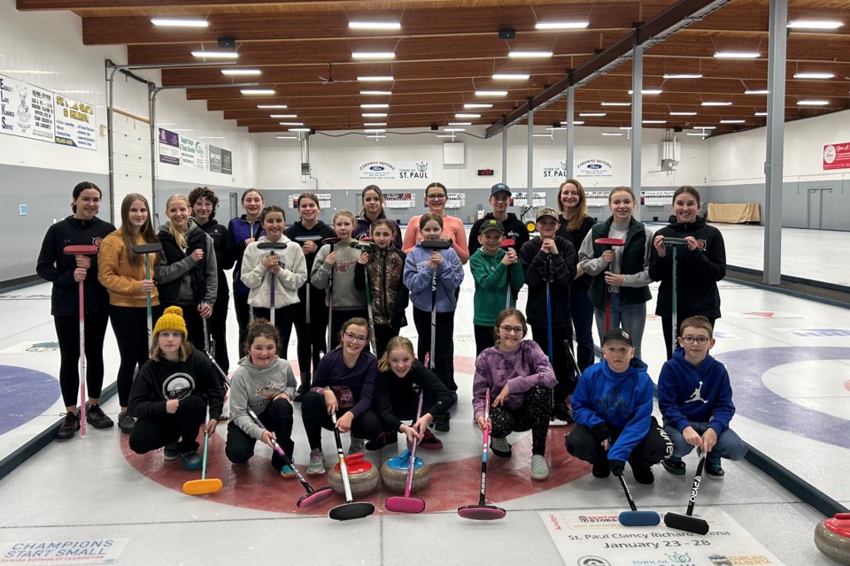This year's curlers and coaches pose for a group photo during the Feb. 24 junior curling bonspiel.