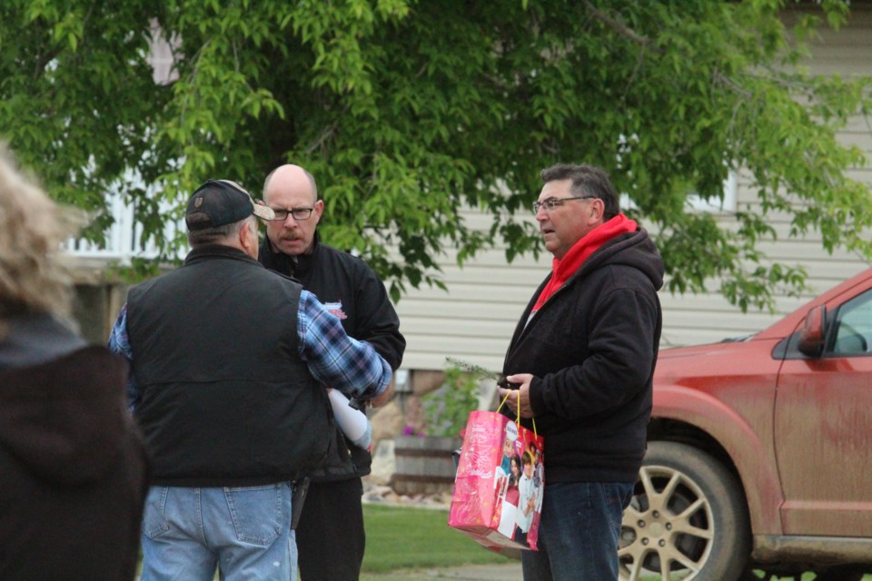 Retiring principal Dan Coonan talks with some of the community members who attended Wednesday's parade