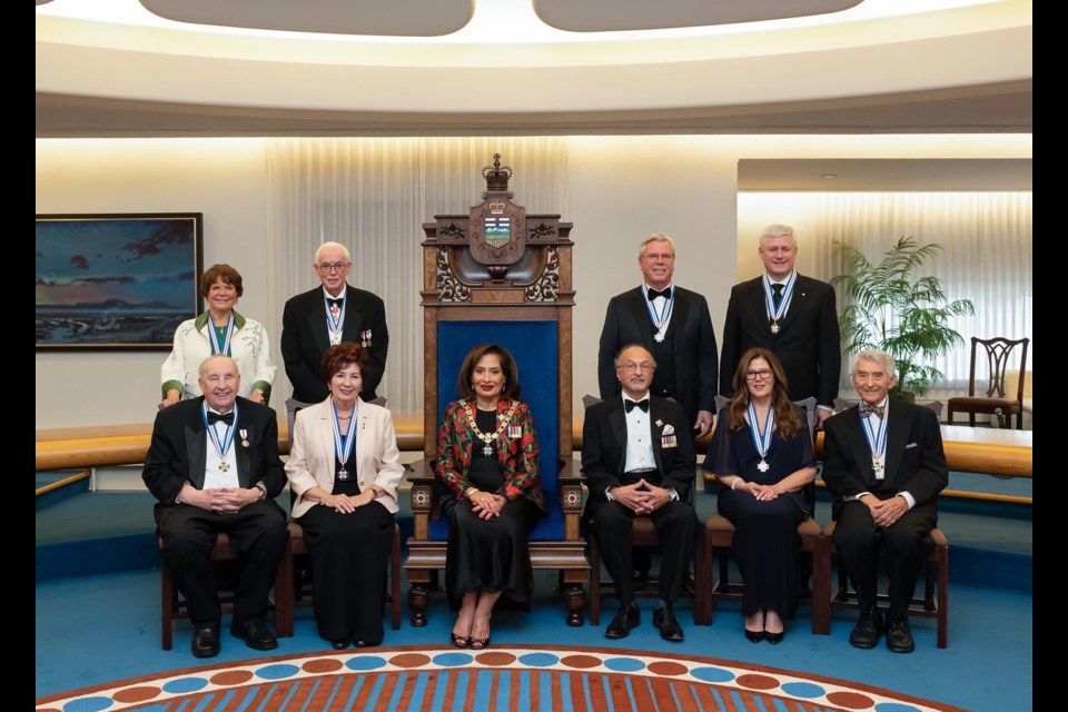 Cold Lake's Audrey McFarlane was among this year's recipients of the Alberta Order of Excellence. McFarlane is pictured sitting second from right. Behind her is fellow inductee former Prime Minister Stephen Harper, along with other 2023 recipients and government representatives.