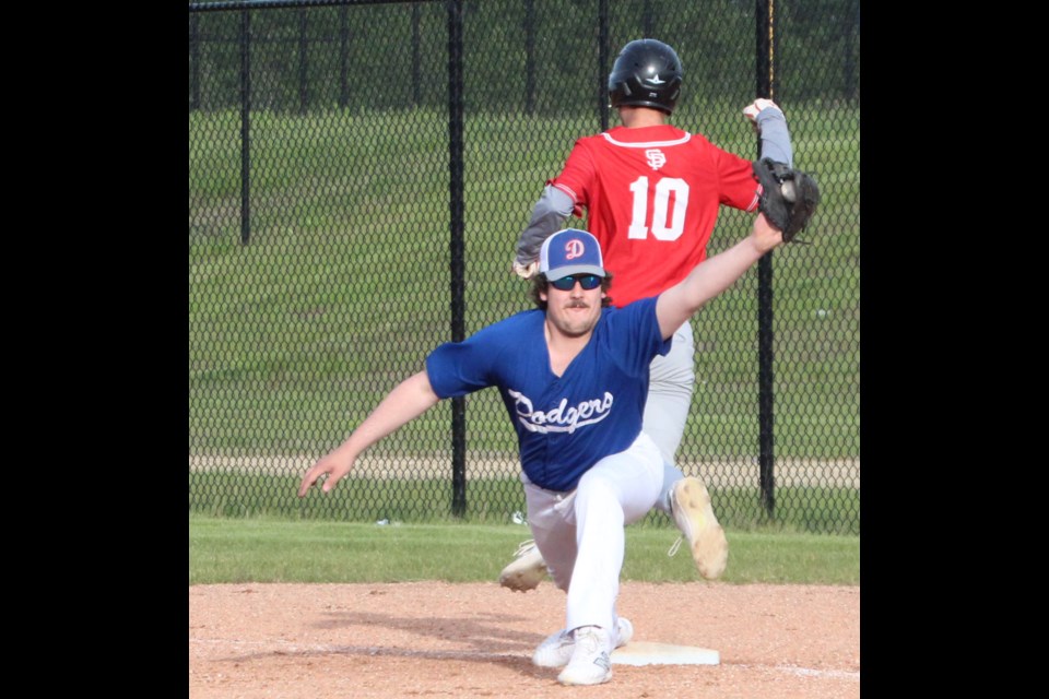 Dodgers' first baseman Dylan McDonald stretches to make the grab during the Tuesday semifinal game between St. Paul and Lac La Biche.
