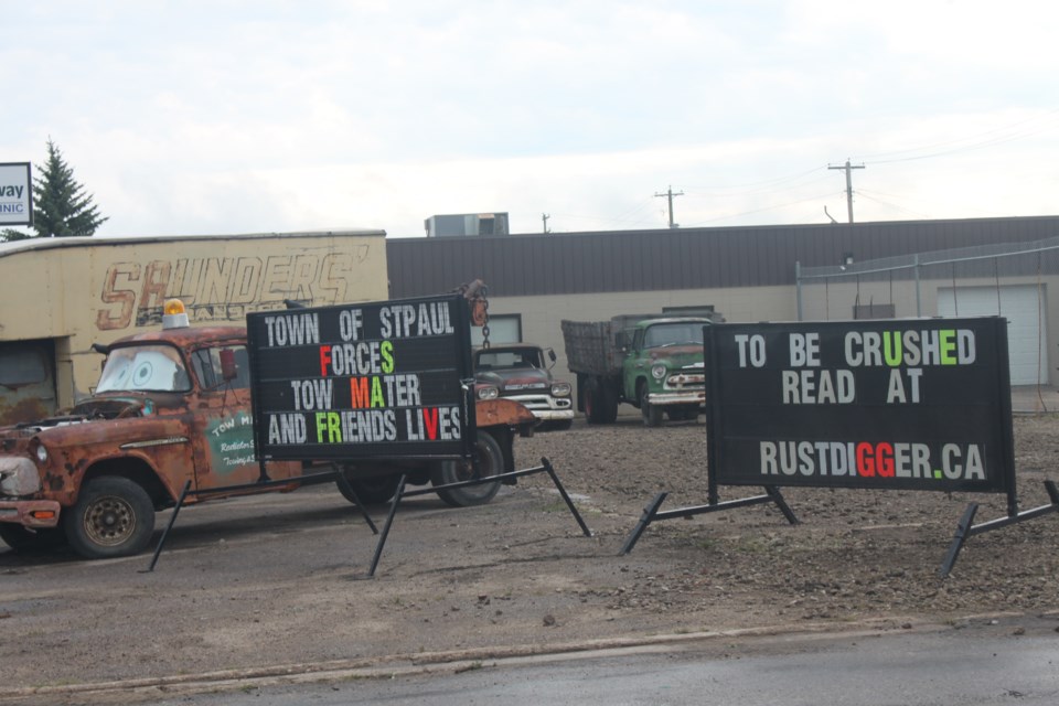 Main Street property owner Kelley Prymych has erected signs on his lot in protest of a Town of St. Paul enforcement order to clean up his lot. For the record, the Town maintains it has not asked Prymych to "crush" any vehicles.
Clare Gauvreau photos