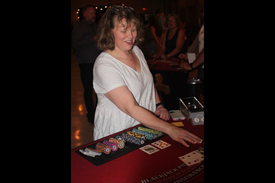 Vicky Thomson volunteers as a card dealer at the Blackjack table during the Aug. 26 casino night hosted by the St. Paul and District Chamber of Commerce. / Clare Gauvreau photo