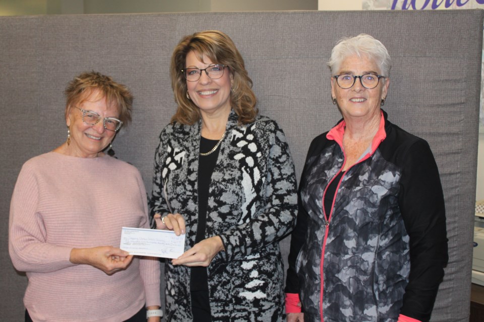 St. John's United Church representatives Jacki Kunec (left) and E. (Bim) Bowers (right) present the proceeds from the Night of Music to Susan White, executive director of the Stepping Stones Crisis Society.       Submitted photo