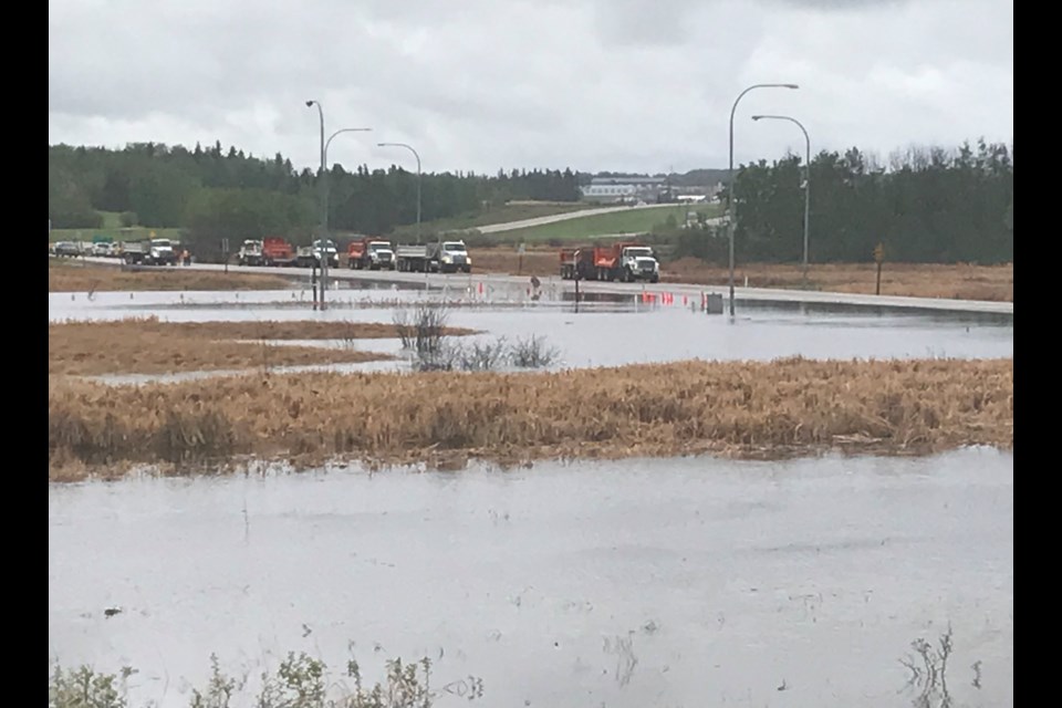 Alberta Transportation crews, municipal peace officers and county public works staff were diverting traffic and creating a bridge over flood waters on Thursday that blocked off the entrance to the hamlet of Lac La Biche.
Image: Jana McKinley
