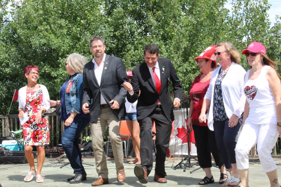 Lac La Biche County Mayor Omer Moghrabi — when his hip was better — dancing at a 2018 Canada Day celebration with officials including MP David Yurdiga. Moghrabi says fun times like these in his own community  are better than any holiday at any time of the year.       Rob McKinley file photo