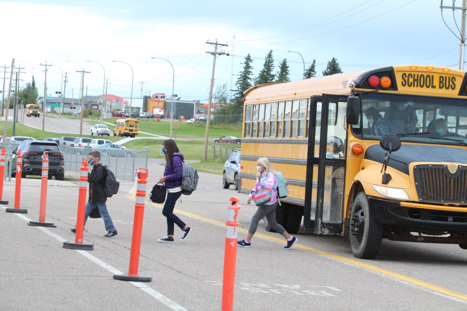 Students arrive for their first day of classes at Aurora Middle School. Students came back to classes in staggered starting days on Tuesday and Wednesday, grouped alphabetically. Thursday was the first day for all students in local classrooms.    Image Rob McKinley