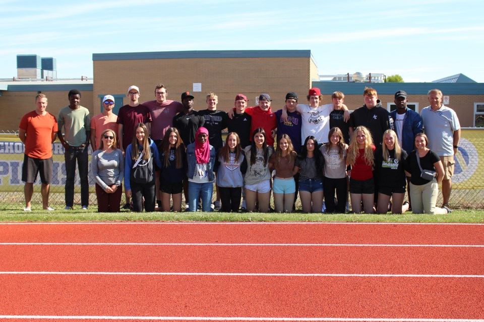 The St. Paul Regional High School Saints take a group photo at the ASAA track and field provincial championship.