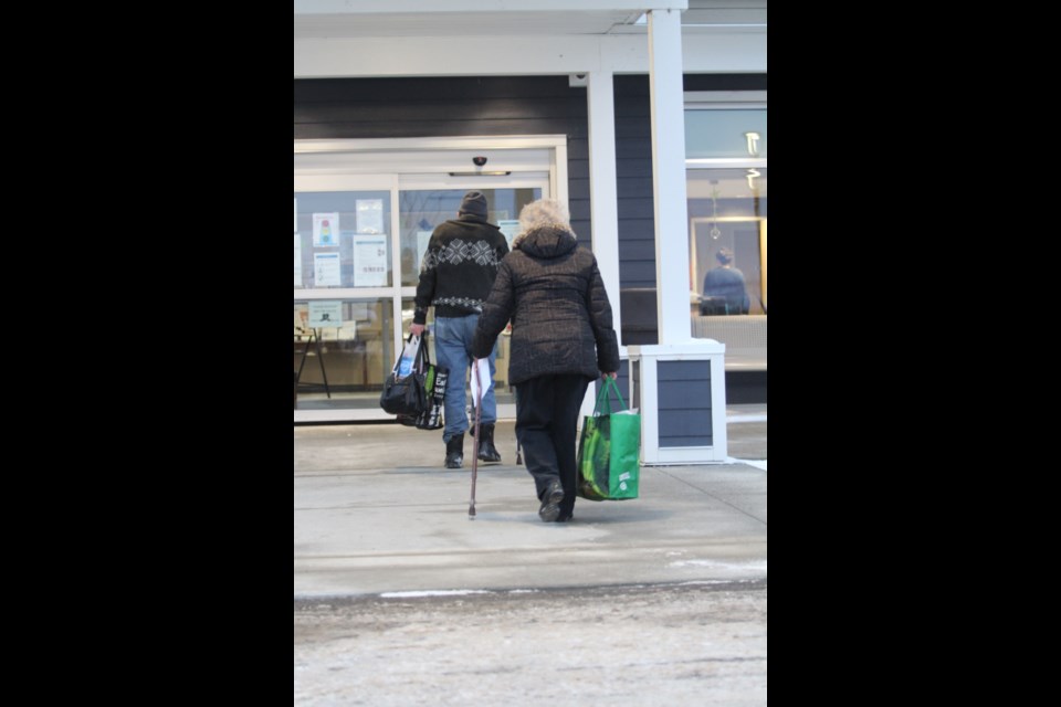 A couple enters the Points West senior complex last Wednesday. No reported cases of the coronavirus have been identified at the facilty. The neighbouring seniors' home, LacAlta Lodge, was in a lockdown last week after an AHS staff member who had visited the building tested positive for COVID-19.  The lockdown resulted in no new cases of the virus at LacAlta.        Image Rob McKinley