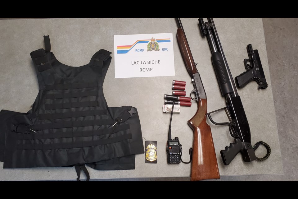 A tactical vest, long-guns, ammunition and a replica Secret Service badge were found by Lac La Biche RCMP in a recent arrest.