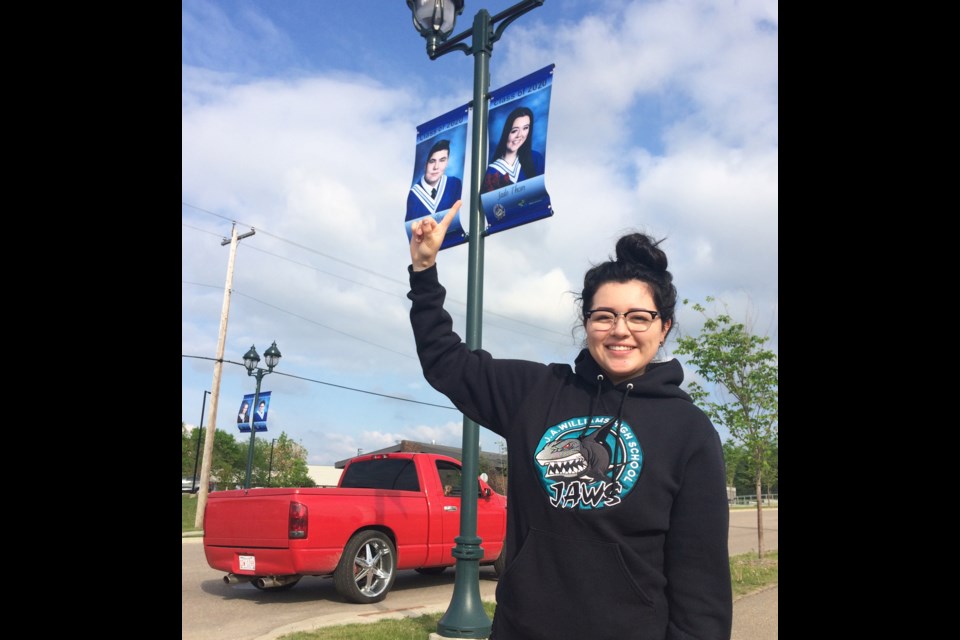 2020 J. A. Williams graduate Jade Thom points up to her grad banner that was on display for last year's first-time version of a COVID graduation celebration.     File Rob McKinley