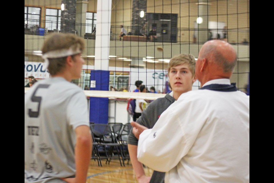 The coin flip by veteran official Maurice Richard to decide service to start a game during the 50th anniversary Wow Pow volleyball weekend