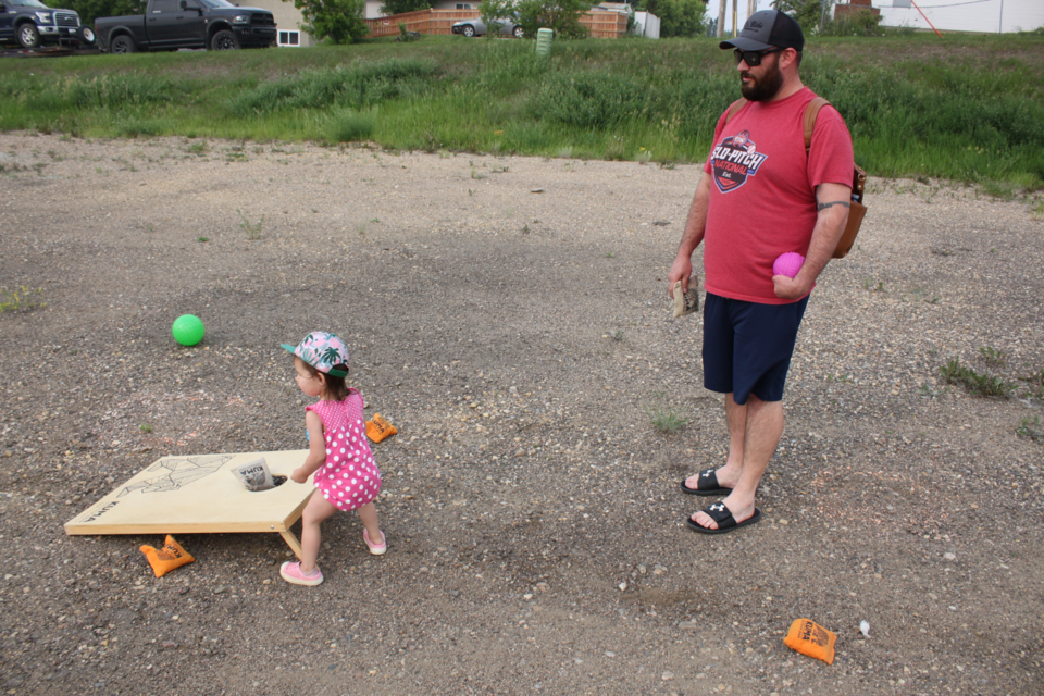 One is never too old nor too young to play games, and on Tuesday evening, Jeff Richard and his daughter, Maverick, enjoyed a game of cornhole bean toss during Tuesday's  Park and Play Fun Van afternoon near the Lac La Biche Museum. 