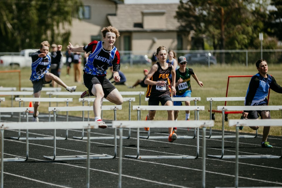 Racette Jr. High student Brodie Huser competes in a hurdles event during the SPAA track and field day.