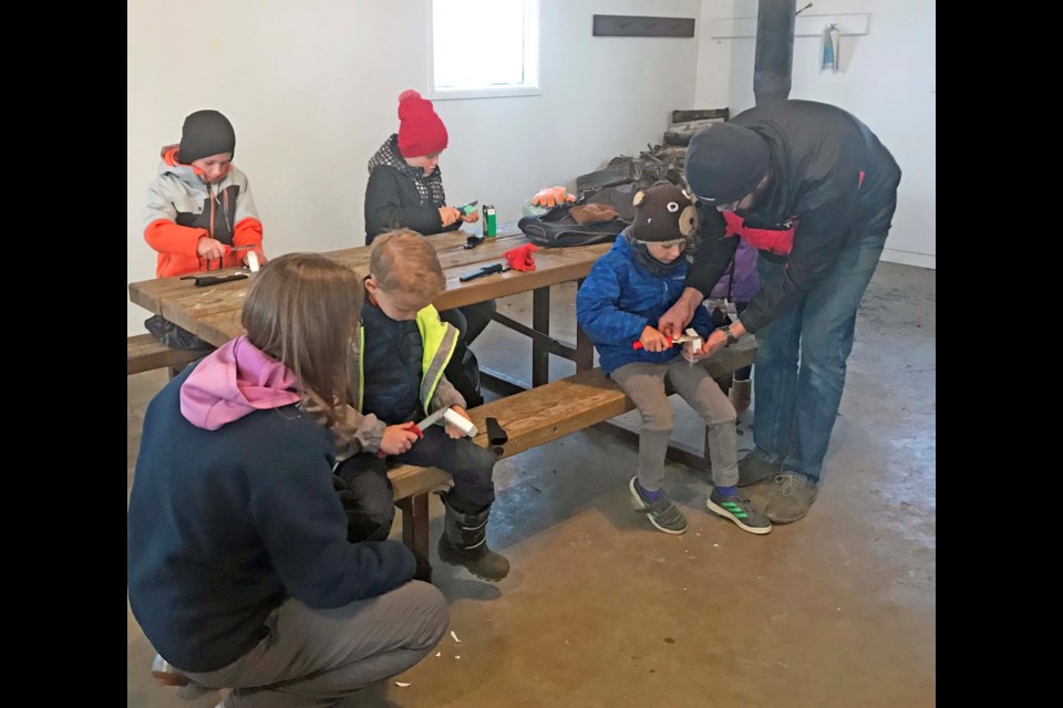 Youngsters enjoy some hands-on knife-safety skills during Friday's Junior Forest Warden meeting in the camping shelter at the Beaver Lake group use site. The Junior Forest Warden program is starting up for another year in the Lac La Biche area, teaching youngsters outdoor recreation skills and environmental lessons. For more info on the program and to register: www.ajfwa.ca         Image Jana McKinley