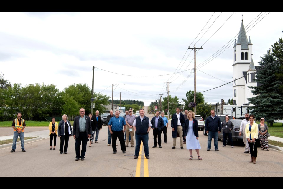 Alberta Premier Jason Kenney is front and centre of a fun photo opp on Aug. 7 to celebrate government approval for paving 800 metres of Highway 858 through Plamondon. Kenney was joined by Alberta Transportation Minister RIc McIver, local MLA Laila Goodridge, Lac La Biche County Mayor Omer Moghrabi, council members and community members.    Image: Gov't of Alberta