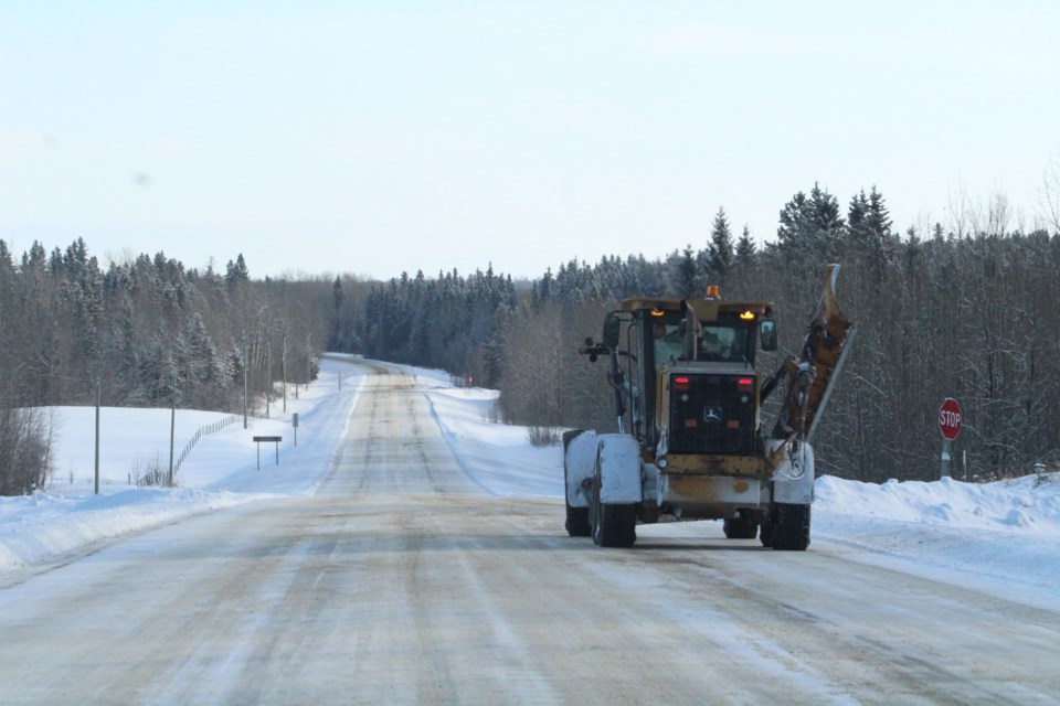 A Lac La Biche County grader works on a long stretch of Highway 858 near Blais Resort following a significant winter snowfall.      Image Rob McKinley