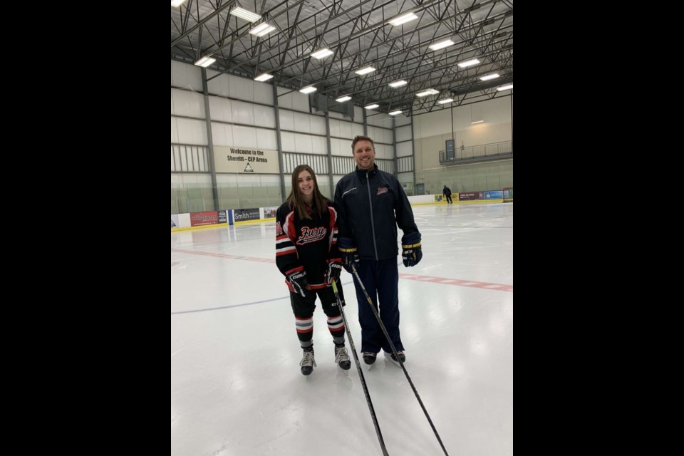 Meghan Henderson stands next to coach Shayne Nent