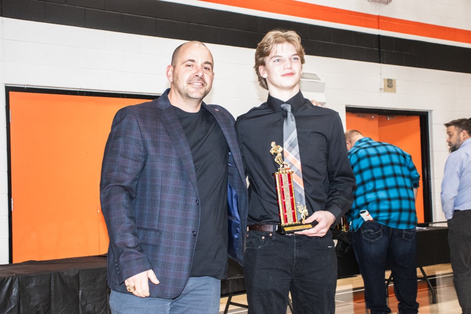 Coach Kurtis Stolth presents the Bengals' Most Valuable Offensive Lineman Award to Blake Dolejsi.