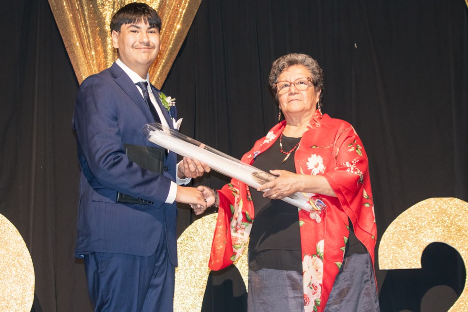 Elder Gloria Halfe (right) present the Eagle Feather to Ashmont School's graduating students.