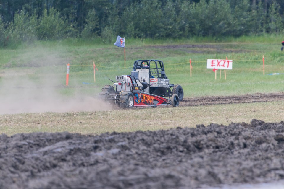 A pair of modified rigs race head-to-head on the drag strip track at the Plamondon Festival Centre on July 13 during the 2025 Plamondon Mud Bogs competition.