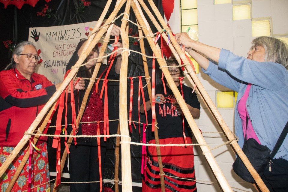 Members of the community wrote the names of their lost, loved ones on red ribbons at the Mannawanis Native Friendship Centre on May 2.