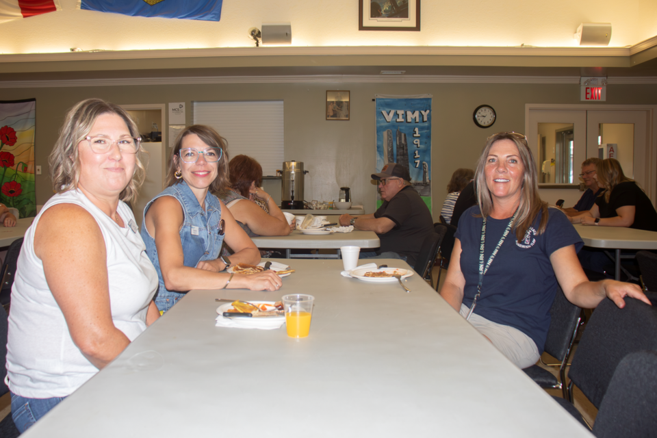 Staff at Primary Care Alberta enjoy some pancake breakfast at the Legion Hall on Aug. 29. The staff have been busy promoting sexual health and vaccine awareness with their mobile outreach van throughout the week.