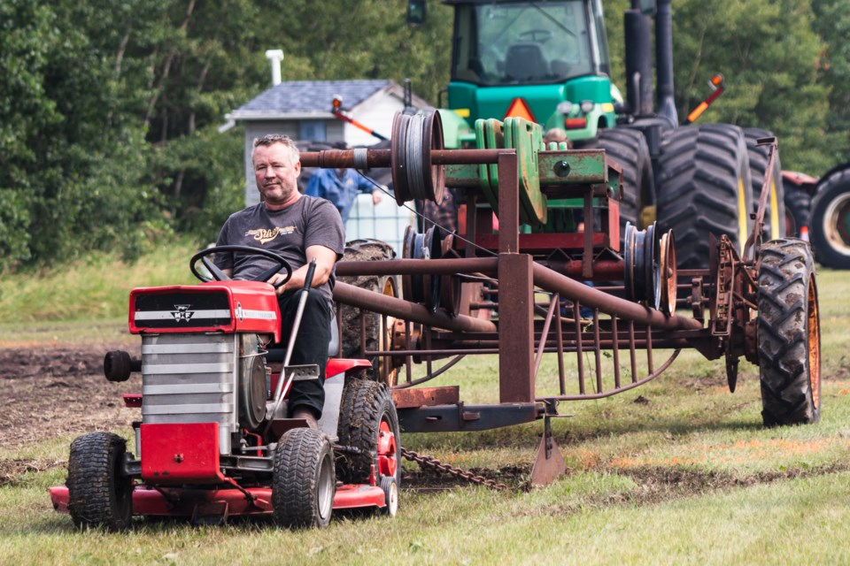 Over a dozen antique tractors and lawnmowers competed to see what ride could pull the most weight during the Ashmont Ag Society's Heritage Days. Pictured is Keith Lilje.  
