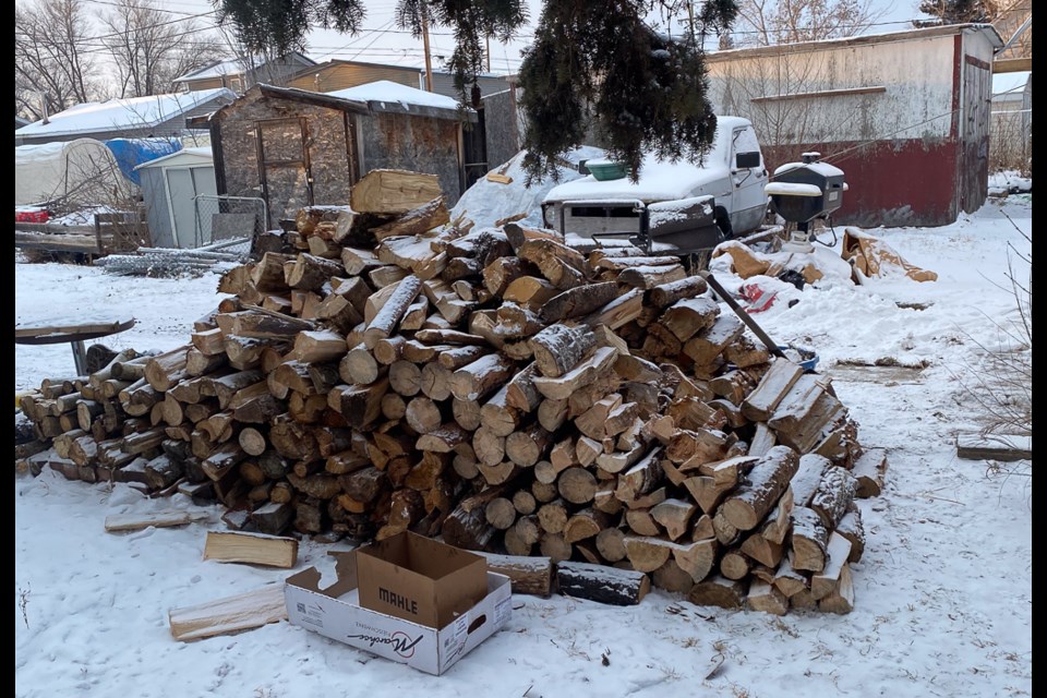Strangers from throughout the region donated wood for Randy. In the background, under the tarp are piles of larger wood, with more piles in the root cellar.