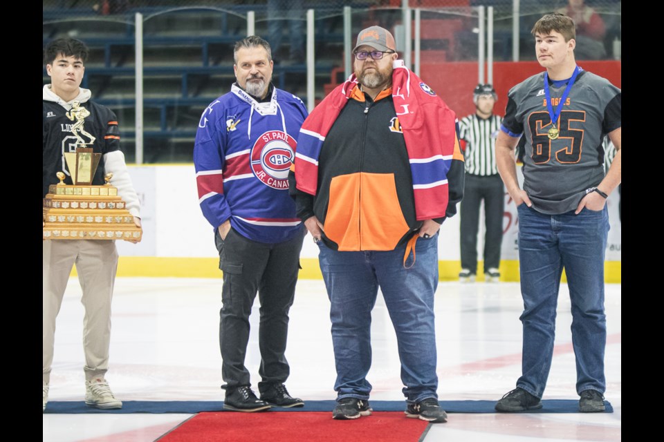 St. Paul Lions head coach Mark Tichkowsky (middle-left) and Bengals head coach Derek Zapisocki on Dec. 1 at the Clancy Richard Arena, during the St. Paul Canadiens paying tribute to the Bengals and the Lions.