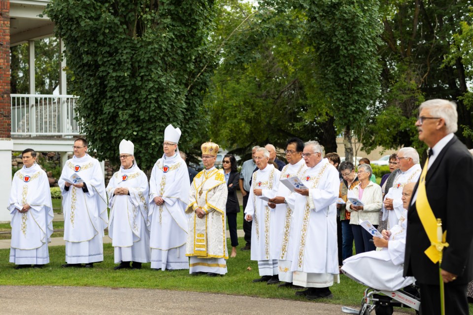 Bishops and deacons are pictured during the blessing of the well on July 17.