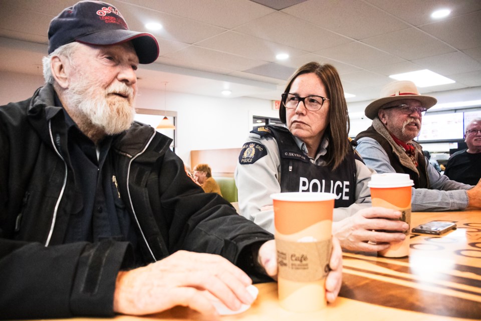 Cpl. Colleen Skyrpan (middle) of the St. Paul RCMP Detachment, sits with residents during the St. Paul RCMP's Coffee with a Cop on Jan. 30. She says it's been interesting to hear the stories of individuals from the community. 