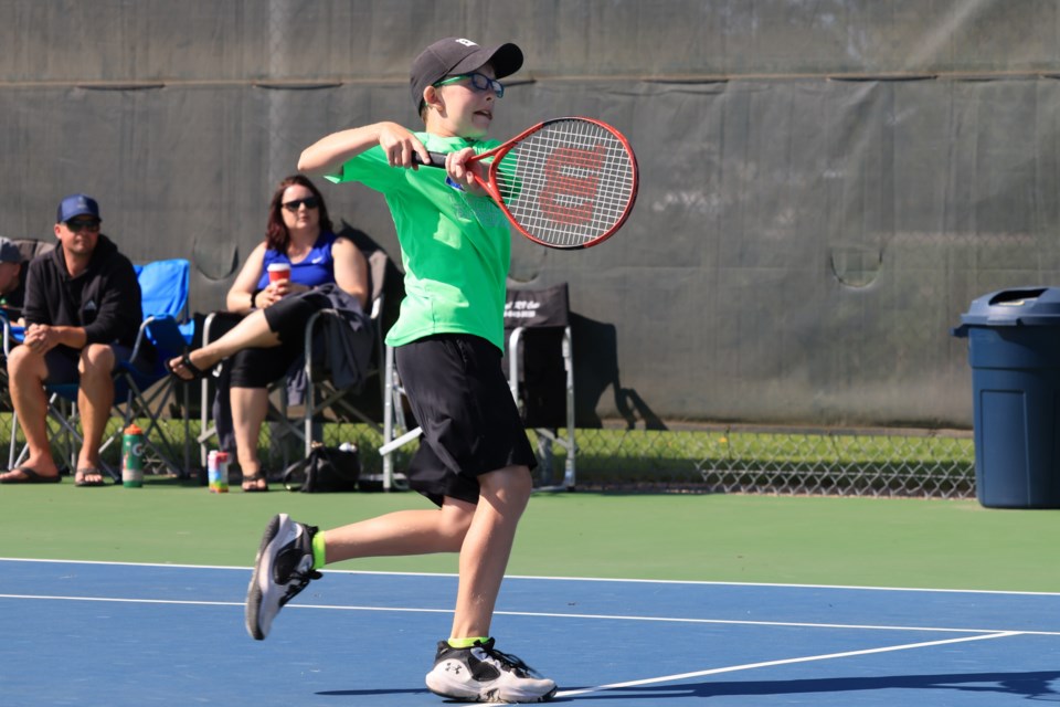 Kyler Morrison competes during the semi-final for singles on Aug. 20 with his parents supporting him the the background.