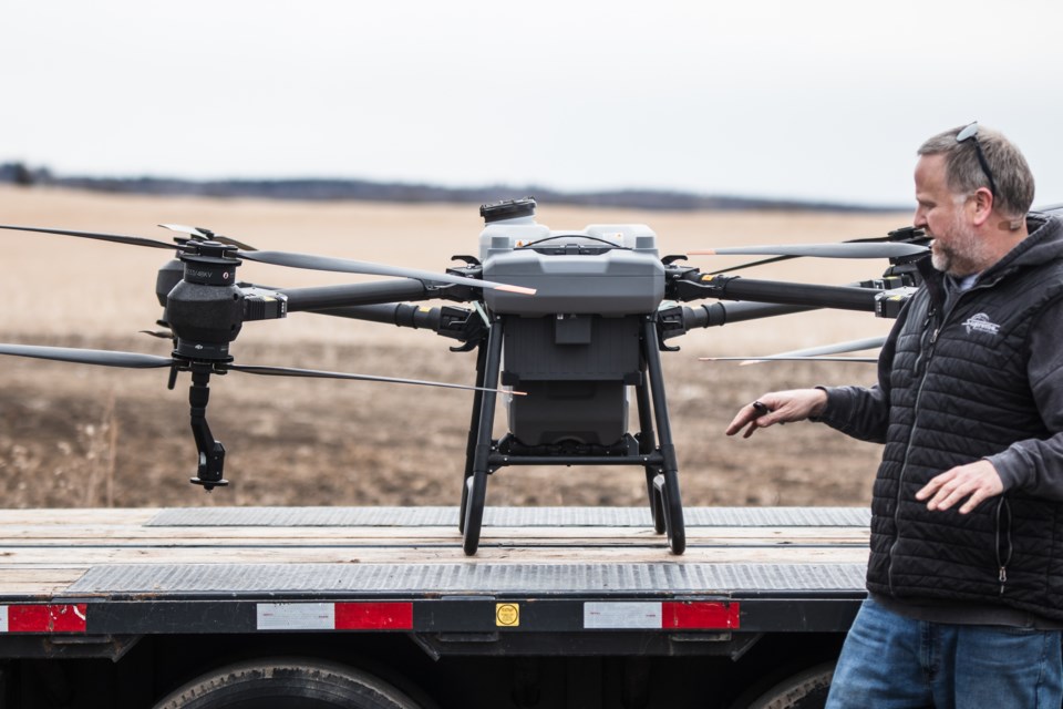 Andrew Morin, sales at Caouette & Sons, speaks about the features of a sprayer drone during a demonstration on April 4 in St. Paul.