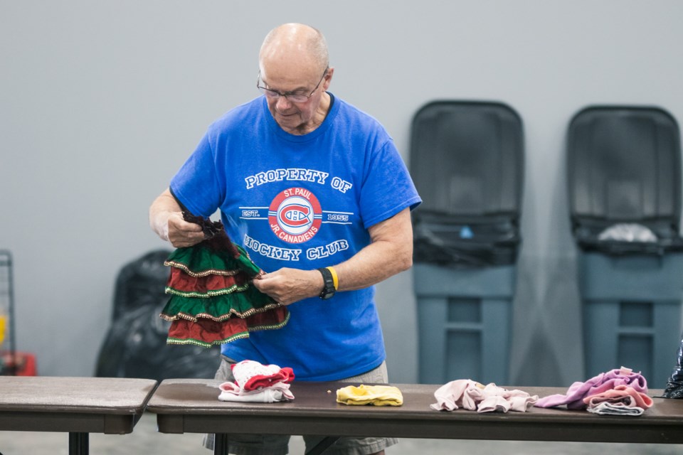 Volunteers work together to organize clothings and items donated by members of the community on May 14 for the St. Paul FCSS' clothing exchange.