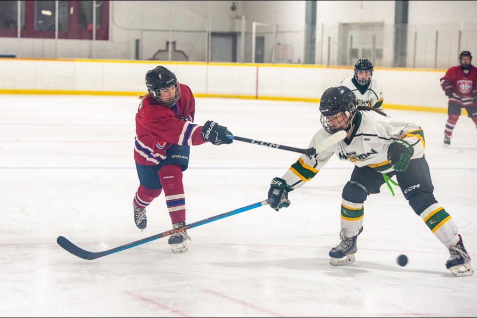 The St. Paul U18 Female Canadiens on the ice against the Sherwood Park Fuzion at the Mundare Arena.