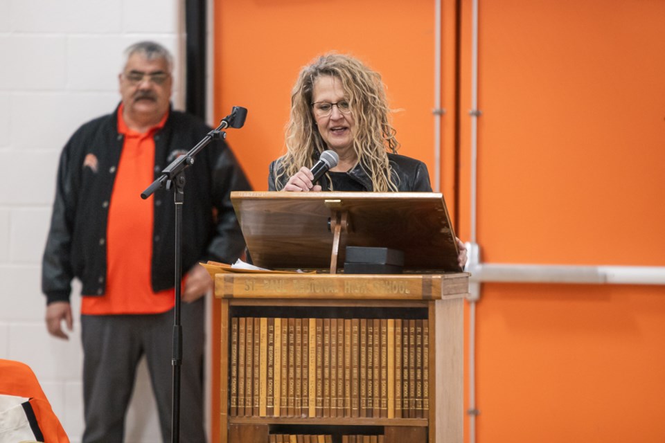 Lorianne Peters, president of St. Paul Football, thanked everyone for their support of the football program this year. On her left is Roger Girard, the night's emcee.