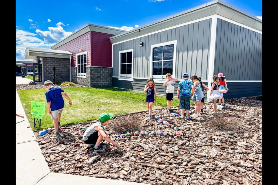 Students at Glen Avon adds their own painted rocks to help "Rocko" grow. 