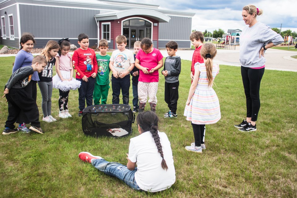 Students from Glen Avon School release butterflies after watching their life cycle.