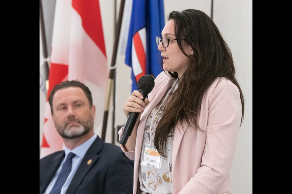 NDP candidate Caitlyn Blake speaks to forum attendees while UCP candidate Scott Cyr listens in.