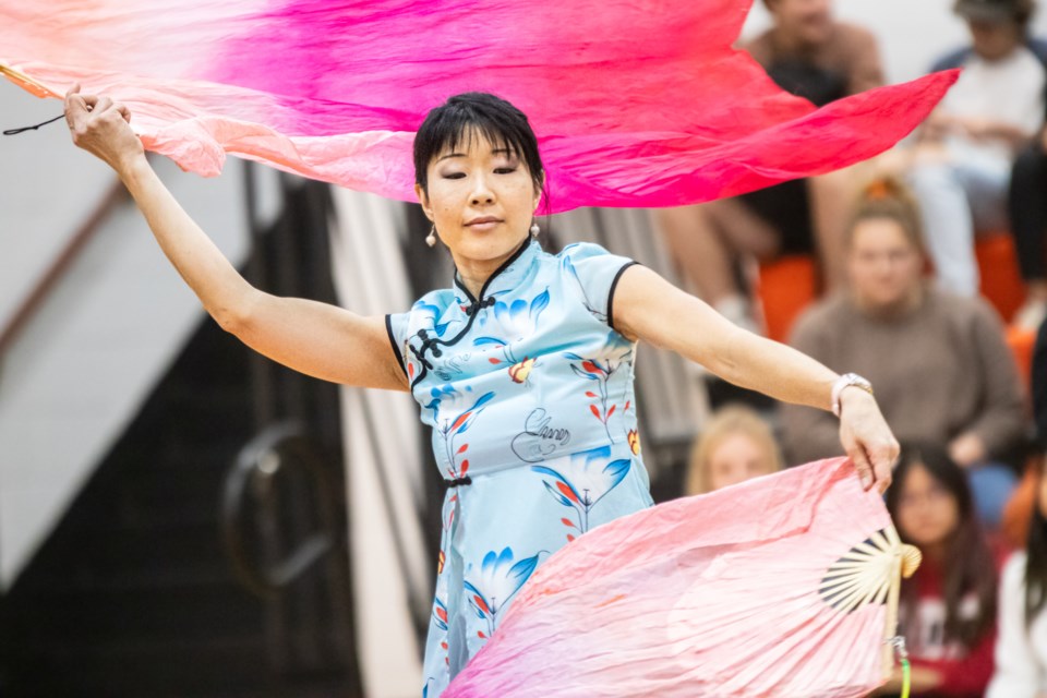 Math and physics teacher Lynda Young performing a dance that incorporates elements from both Chinese and New Zealander dance traditions.