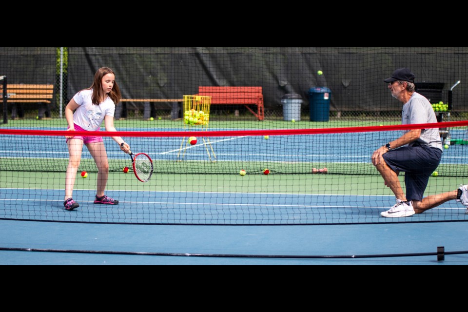 Eva Poirier (left) and Dave Shankowski (right) practice a hitting drill during the June 4 St. Paul Tennis Club Annual Rally. 