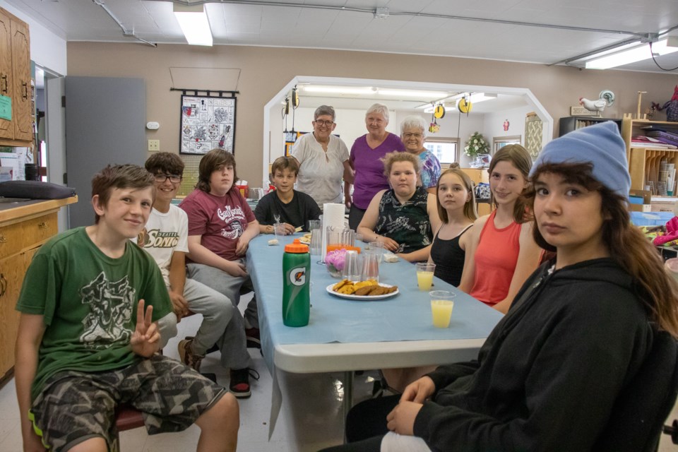 A class of Grade 7 students from Glen Avon made a field trip to the Quilting Bees Guild. Behind them (from left to right) are Elaine Proctor, class teacher Patti Krekoski, and Angele Duncan. Proctor and Duncan helped the class with their sewing projects.