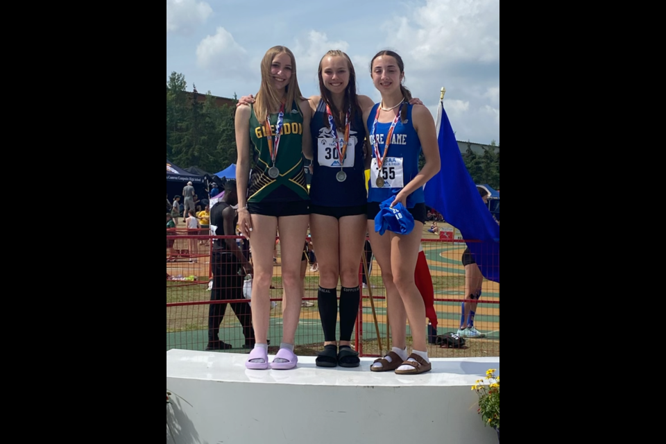 Mady Luciak (left) poses for a photo with co-medalists during the 2023 ASAA Track & Field Provincials.
