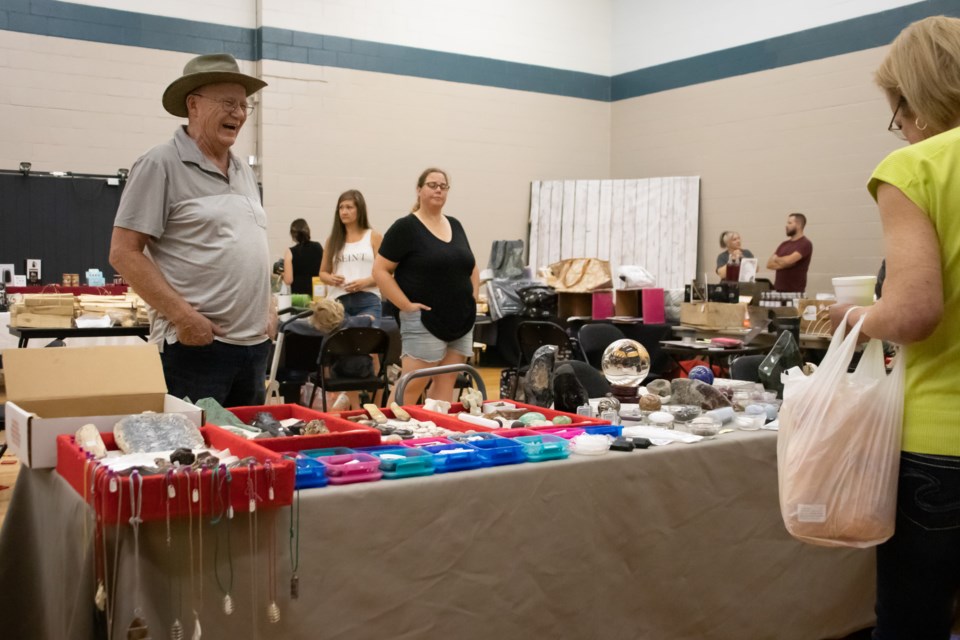 Gary Pollom speaks with a customer about his crystals.